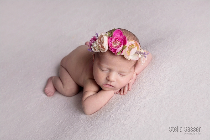 newborn on lace backdrop with flower crown