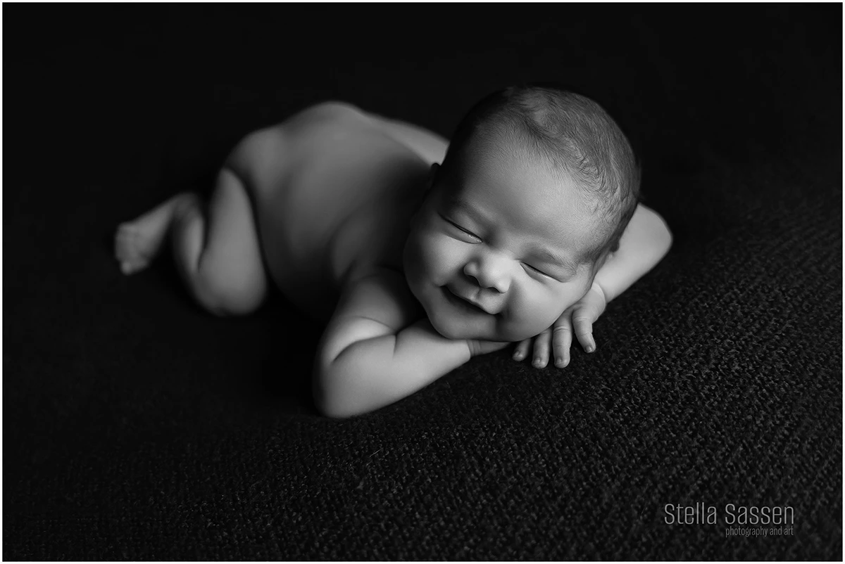 newborn baby posing and smiling
